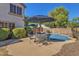 Charming backyard with a private pool, an outdoor dining area, and lush landscaping for relaxed entertaining at 2545 E Harrison Ct, Gilbert, AZ 85295