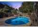 Sparkling backyard pool with desert landscaping, a built-in grill and fire pit, creating an oasis at 2545 E Harrison Ct, Gilbert, AZ 85295