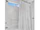 Bright bathroom showcasing a bathtub and a white shower curtain with a window above at 2545 E Harrison Ct, Gilbert, AZ 85295