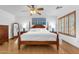 Spacious primary bedroom with hardwood floors, king bed, and en suite bathroom at 2545 E Harrison Ct, Gilbert, AZ 85295
