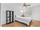 Bright bedroom features hardwood floors, a ceiling fan and a large bed at 2545 E Harrison Ct, Gilbert, AZ 85295