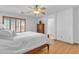 Bright bedroom with hardwood floors, ceiling fan, and a window with blinds at 2545 E Harrison Ct, Gilbert, AZ 85295