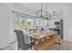 Bright dining area with sliding glass doors to backyard and modern lighting fixtures at 2545 E Harrison Ct, Gilbert, AZ 85295