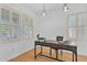 Bright office space featuring two windows with plantation shutters and hardwood floors at 2545 E Harrison Ct, Gilbert, AZ 85295