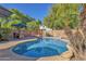 Serene backyard featuring a private pool, an outdoor kitchen with bar seating, and mature trees for added privacy at 2545 E Harrison Ct, Gilbert, AZ 85295