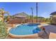 Beautiful backyard with a sparkling private pool, palm trees, and a seating area for outdoor enjoyment at 2545 E Harrison Ct, Gilbert, AZ 85295