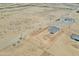 Aerial shot of desert home with fenced yard and surrounding expansive desert landscape at 25893 W Running Deer Trl, Wittmann, AZ 85361