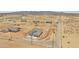 Wide aerial shot showcasing desert community homes with fenced yards and ample land at 25893 W Running Deer Trl, Wittmann, AZ 85361