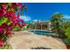 Inviting backyard with pool, stone patio, palm trees, and vibrant bougainvillea at 6428 E Nisbet Rd, Scottsdale, AZ 85254