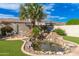 Picturesque backyard with a rock pond, lush artificial turf, and mature landscaping at 6428 E Nisbet Rd, Scottsdale, AZ 85254
