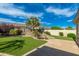 Serene backyard featuring a rock pond, mature landscaping, and well-manicured artificial grass at 6428 E Nisbet Rd, Scottsdale, AZ 85254