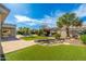 Expansive backyard view showcasing the rock pond, patio, and lush landscaping at 6428 E Nisbet Rd, Scottsdale, AZ 85254
