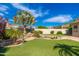 Lush backyard with rock pond, artificial grass, palm trees, and seating area at 6428 E Nisbet Rd, Scottsdale, AZ 85254
