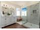 Bright bathroom featuring marble floors, a glass shower enclosure, and a double vanity at 6428 E Nisbet Rd, Scottsdale, AZ 85254