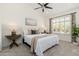 Bright bedroom featuring a ceiling fan, neutral decor, and window with shutter blinds at 6428 E Nisbet Rd, Scottsdale, AZ 85254