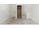 Bright bedroom featuring neutral decor, mirrored sliding closet doors, and hardwood flooring at 6428 E Nisbet Rd, Scottsdale, AZ 85254