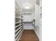 Spacious walk-in closet with custom shelving and organization system, hardwood flooring at 6428 E Nisbet Rd, Scottsdale, AZ 85254