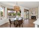Dining room with a modern light fixture and views of the pool area at 6428 E Nisbet Rd, Scottsdale, AZ 85254