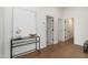 Bright hallway featuring neutral decor, a glass table, and hardwood flooring at 6428 E Nisbet Rd, Scottsdale, AZ 85254