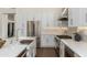 Modern kitchen with stainless steel appliances, farmhouse sink, and white cabinets at 6428 E Nisbet Rd, Scottsdale, AZ 85254