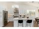 Open kitchen with stainless steel appliances, island, and breakfast bar seating at 6428 E Nisbet Rd, Scottsdale, AZ 85254