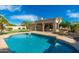 Inviting backyard pool complete with stone patio, green lawn, and ample space for entertaining at 6428 E Nisbet Rd, Scottsdale, AZ 85254