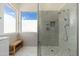 Modern marble shower with glass enclosure, bench seat, and multiple shower heads at 6428 E Nisbet Rd, Scottsdale, AZ 85254
