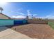 Spacious backyard area features a colorful block wall, and gravel, perfect for customization at 702 W Sequoia Dr, Phoenix, AZ 85027