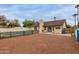 View of backyard with fence surrounding pool and covered patio with sliding glass doors in this lovely home at 702 W Sequoia Dr, Phoenix, AZ 85027