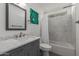 Charming bathroom featuring a gray vanity, white marble countertop and shower/tub combo with new tile at 702 W Sequoia Dr, Phoenix, AZ 85027
