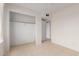 Tiled bedroom with a walk-in closet and white trim at 702 W Sequoia Dr, Phoenix, AZ 85027