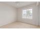 Bright, tiled-floor bedroom features a ceiling fan and a window with blinds at 702 W Sequoia Dr, Phoenix, AZ 85027