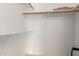 An empty closet featuring white walls and multiple shelves at 702 W Sequoia Dr, Phoenix, AZ 85027