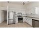 Well-equipped kitchen featuring stainless steel appliances, white cabinets and tile flooring at 702 W Sequoia Dr, Phoenix, AZ 85027