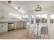 Bright eat-in kitchen with stainless steel appliances, white cabinetry, and lots of natural light at 702 W Sequoia Dr, Phoenix, AZ 85027
