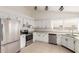 Well-lit kitchen with white cabinetry, stainless steel appliances, and a functional layout for cooking at 702 W Sequoia Dr, Phoenix, AZ 85027