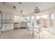Bright kitchen with white cabinets, stainless steel appliances, and an adjacent dining area with backyard views at 702 W Sequoia Dr, Phoenix, AZ 85027
