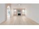 Bright living room with a white brick fireplace, tile flooring, and large windows, perfect for gatherings at 702 W Sequoia Dr, Phoenix, AZ 85027