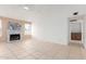 Spacious living room with a painted brick fireplace, tile flooring, and ample natural light at 702 W Sequoia Dr, Phoenix, AZ 85027