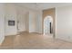 Spacious living area with neutral tile flooring and arched access to the kitchen at 702 W Sequoia Dr, Phoenix, AZ 85027