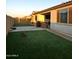Spacious backyard with artificial grass, patio, and covered seating, perfect for outdoor entertaining at 7616 W Jones Ave, Phoenix, AZ 85043