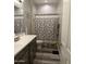 Bathroom with dual vanity sinks, butterfly-themed shower curtain, and wood-look tile flooring at 7616 W Jones Ave, Phoenix, AZ 85043