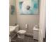Charming half-bathroom features stylish decor, modern fixtures, and wood-look tile flooring at 7616 W Jones Ave, Phoenix, AZ 85043