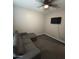 This neutral bedroom offers a ceiling fan and a wall-mounted TV for comfortable and relaxed living at 7616 W Jones Ave, Phoenix, AZ 85043