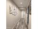Hallway boasts modern decor, wood-look tile flooring, and recessed lighting, creating a welcoming entrance at 7616 W Jones Ave, Phoenix, AZ 85043