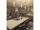Spacious kitchen features granite countertops, stainless steel appliances, and a large island with seating at 7616 W Jones Ave, Phoenix, AZ 85043
