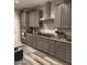 Well-equipped kitchen offers stainless steel appliances, gray cabinetry, and granite countertops at 7616 W Jones Ave, Phoenix, AZ 85043
