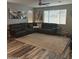 Spacious living room with a large sectional sofa, neutral rug, and modern decor at 7616 W Jones Ave, Phoenix, AZ 85043