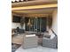 Relaxing covered patio featuring comfortable seating, potted trees, and a mounted television at 7616 W Jones Ave, Phoenix, AZ 85043