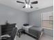 Cozy bedroom with light gray walls, a ceiling fan, and a window providing natural light at 8524 S 49Th Ln, Laveen, AZ 85339